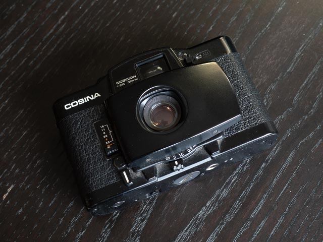 Cosina CX-2 showing the focussing leave and distance scale below the lens.