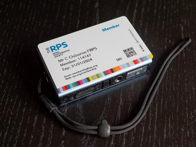 Canon Digital Ixus 82 IS lying underneat my credit card sized RPS membership card